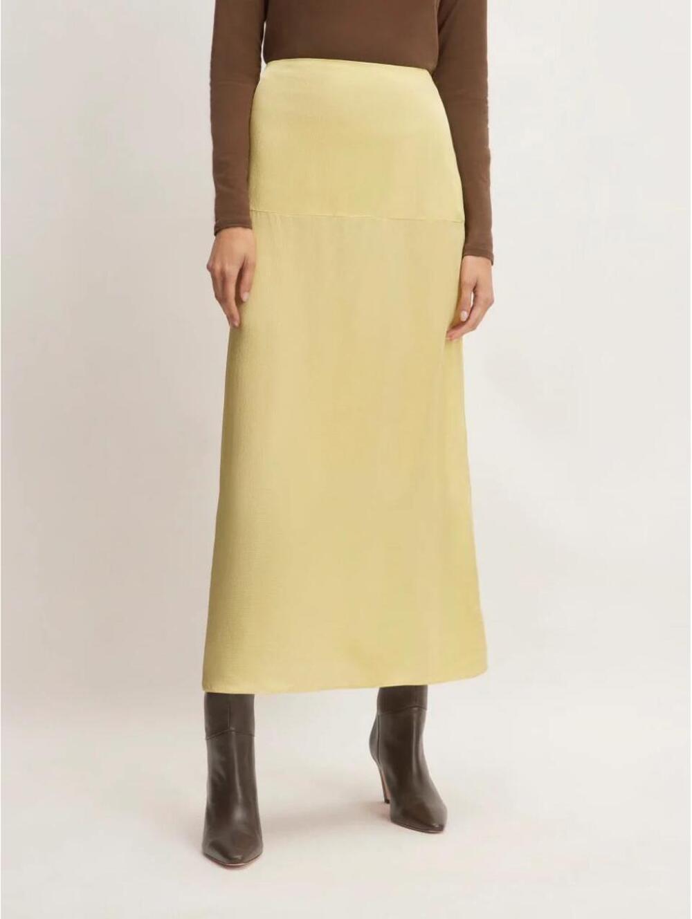 The Hammered Satin Slip Midi Skirt by Everlane in a chartreuse yellow color.